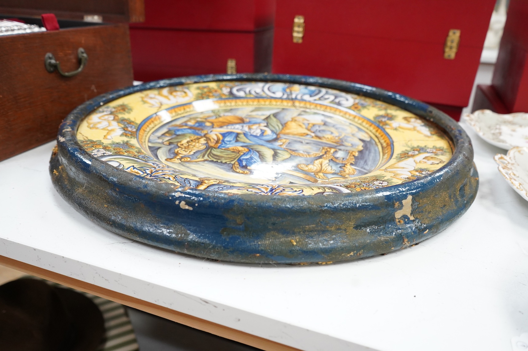 A 19th century Italian maiolica istoriata charger (riveted), framed, 56cm in diameter overall